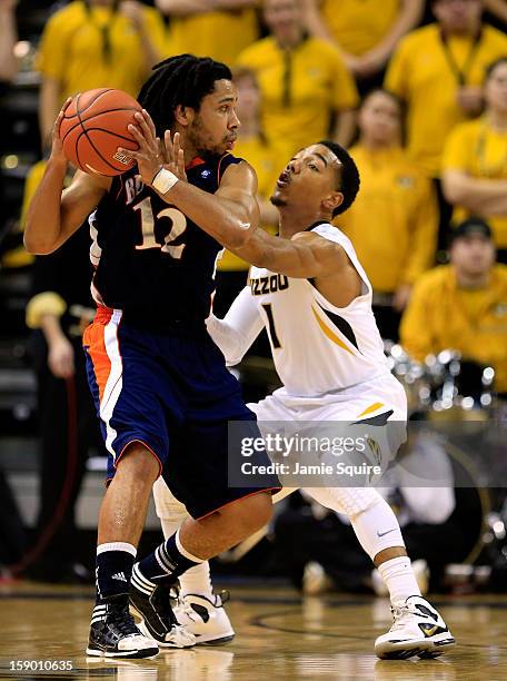 Bryson Johnson of the Bucknell Bison controls the ball as Phil Pressey of the Missouri Tigers defends during the game at Mizzou Arena on January 5,...