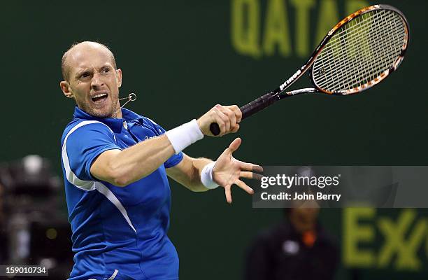 Nikolay Davydenko of Russia plays a forehand during the final against Richard Gasquet of France on day six of the Qatar Open 2013 at the Khalifa...