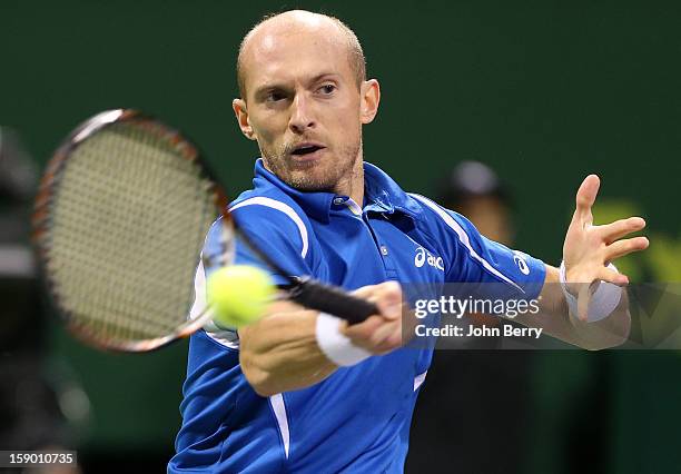 Nikolay Davydenko of Russia plays a forehand during the final against Richard Gasquet of France on day six of the Qatar Open 2013 at the Khalifa...