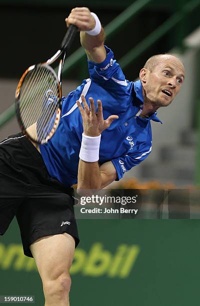 Nikolay Davydenko of Russia serves during the final against Richard Gasquet of France on day six of the Qatar Open 2013 at the Khalifa International...