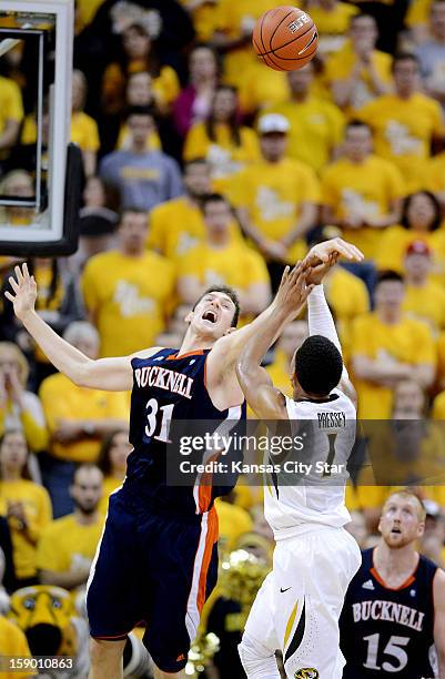 Missouri's Phil Pressey gets fouled by Bucknell's Mike Muscala on a three-point attempt in the second half at Mizzou Arena in Columbia, Missouri,...