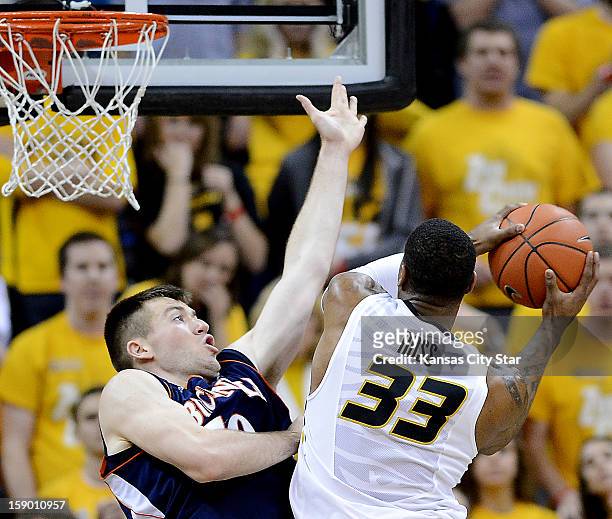 Missouri's Earnest Ross drives hard to the basket against Bucknell's Brian Fitzpatrick in the second half at Mizzou Arena in Columbia, Missouri,...