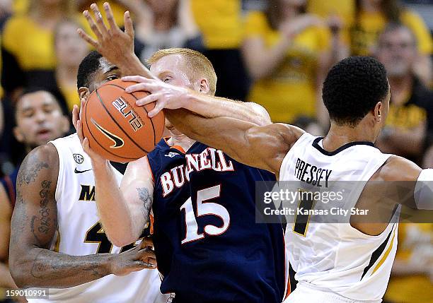 Bucknell's Joe Willman gets tangled up with Missouri's Phil Pressey, right, and Alex Oriakhi in the first half at Mizzou Arena in Columbia, Missouri,...