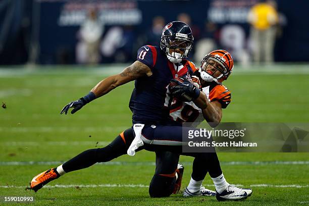 DeVier Posey of the Houston Texans makes a reception against Leon Hall of the Cincinnati Bengals during their AFC Wild Card Playoff Game at Reliant...