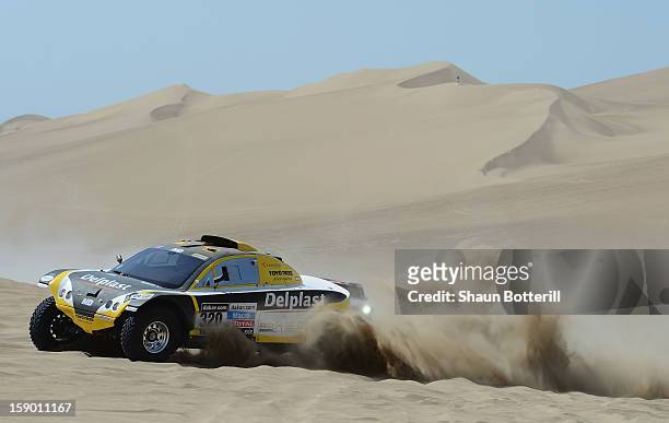 Regis Delahaye and co-pilot Alexandre Winocq of team Buggy MD Rallye compete in the special stage during day one of the of the 2013 Dakar Rally on...