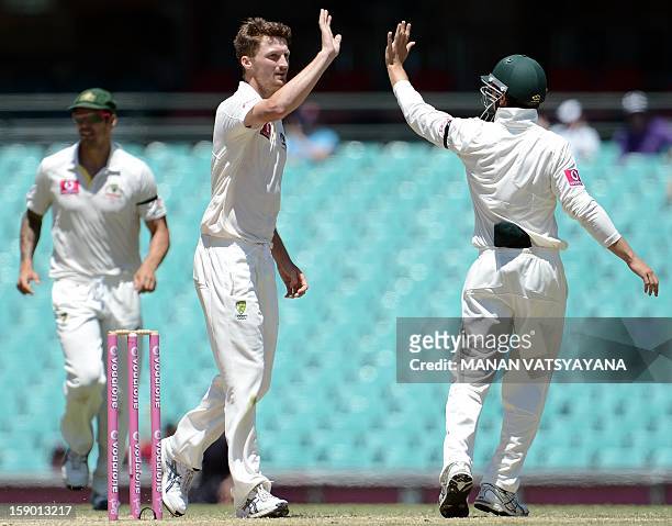 Australian fastbowler Jackson Bird celebrates with teammates after taking the wicket of unseen Sri Lankan batsman Nuwan Pradeep on the fourth day of...