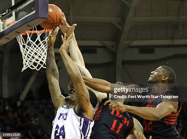 Texas Christian University's Adrick McKinney, left, tries to score against Texas Tech's Dejan Kravic and Jordan Tolbert in the first half at...