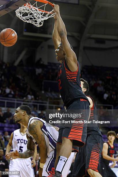 Texas Tech's Jordan Tolbert dunks over Texas Christian Univeristy's Adrick McKinney in the second half at Daniel-Meyer Coliseum in Fort Worth, Texas,...