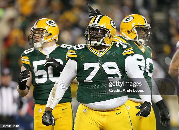 Defensive end Ryan Pickett of the Green Bay Packers reacts in front of teammates inside linebacker A.J. Hawk and nose tackle B.J. Raji in the second...