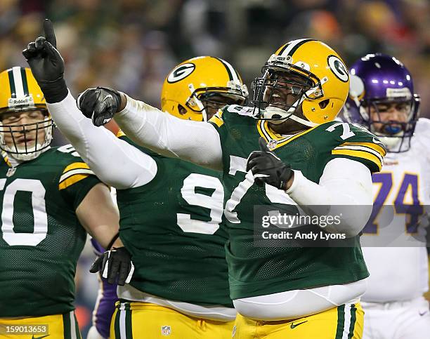 Defensive end Ryan Pickett of the Green Bay Packers reacts in front of teammates inside linebacker A.J. Hawk and nose tackle B.J. Raji in the second...