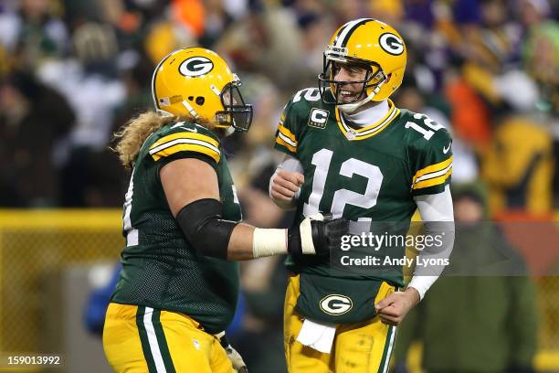 Quarterback Aaron Rodgers and guard Josh Sitton of the Green Bay Packers celebrate after fullback John Kuhn scorers on a nine-yard catch and run in...