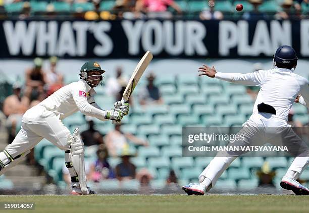 Australian batsman Phillip Hughes watches the ball after playing a shot on the fourth day of the third cricket Test match between Australia and Sri...