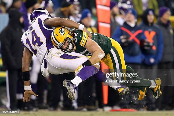 Quarterback Joe Webb of the Minnesota Vikings is hit by outside linebacker Clay Matthews of the Green Bay Packers after throwing the ball in the...