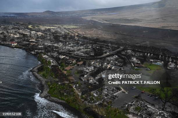 An aerial view shows destruction caused by a wildfire in Lahaina, on the Hawaiian island of Maui, on August 10, 2023. At least 36 people have died...