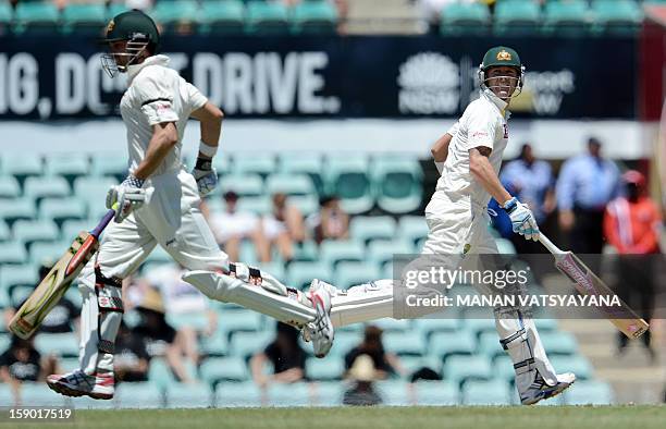 Australian cricket captain Michael Clarke and teammate Ed Cowan run between the wickets on the fourth day of the third cricket Test match between...