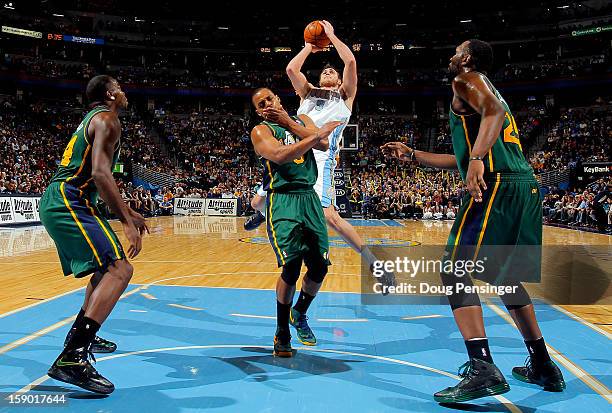 Danilo Gallinari of the Denver Nuggets puts up a shot against Randy Foye of the Utah Jazz as Paul Millsap of the Utah Jazz and Al Jefferson of the...