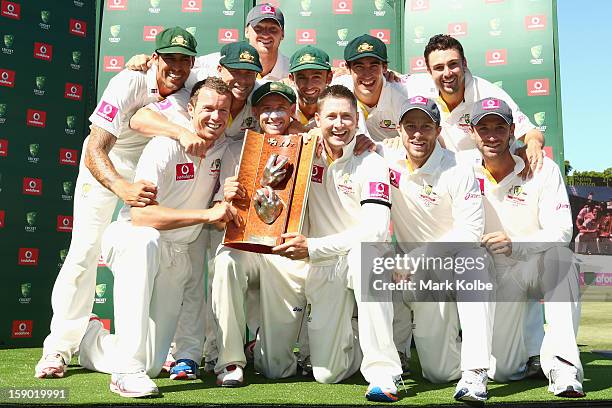 The Australian team pose with the Warne–Muralidaran trophy as they celebrate victory on day four of the Third Test match between Australia and Sri...