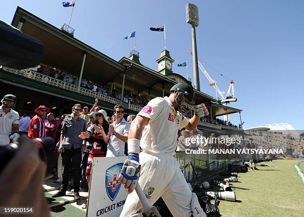 Australian cricketer Michael Hussey walks out to bat for the last time after tea on the fourth day of the third cricket Test match between Australia...