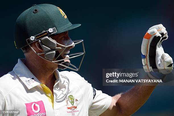 Australian cricketer Michael Hussey gestures as he walks off the field after his team defeated Sri Lanka on the fourth day of the third cricket Test...