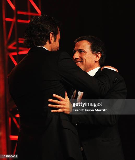 Actor Bradley Cooper accepts the Desert Palm Achievement Award and David O. Russell onstage during the 24th annual Palm Springs International Film...