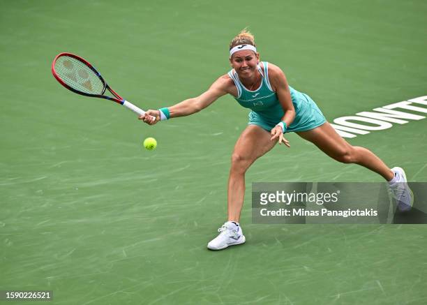 Marie Bouzkova of the Czech Republic reaches for the ball in her match against Daria Kasatkina on Day 4 during the National Bank Open at Stade IGA on...