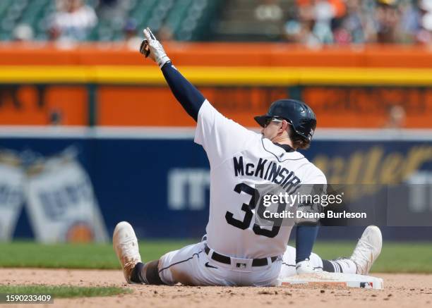 Zach McKinstry of the Detroit Tigers sits at second base after hitting a double to drive in two runs against the Minnesota Twins in the seventh...