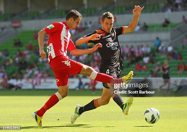 Josip Tadic of the Heart and Matthew Jurman of the Roar compete for the ball during the round 15 A-League match between the Melbourne Heart and the...