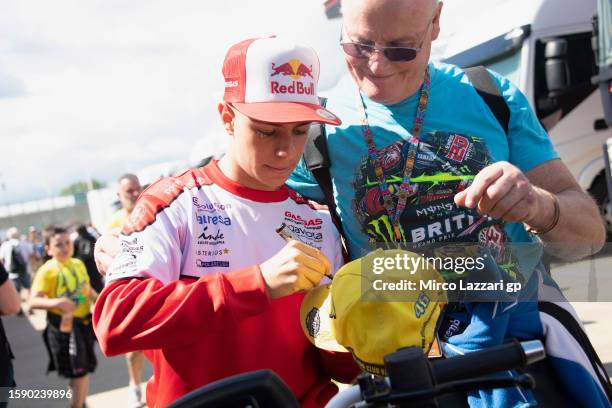 David Alonso of Colombia and GasGas Aspar Team signs autographs for fans during the "Two Wheels For Life" event in the paddock ahead of the MotoGP of...