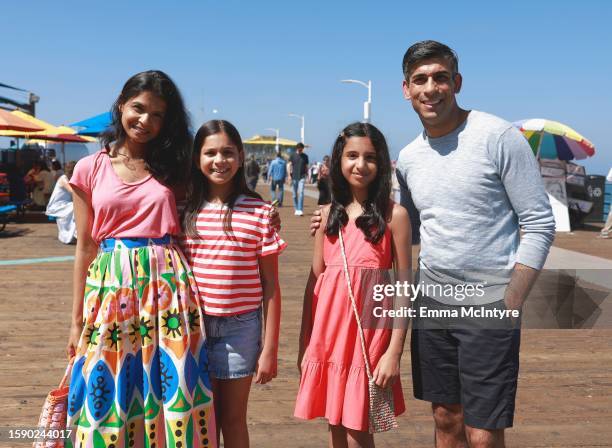 Akshata Murty, Krishna Sunak, Anoushka Sunak and UK Prime Minister Rishi Sunak pose for a photo at Santa Monica Pier on August 03, 2023 in Santa...
