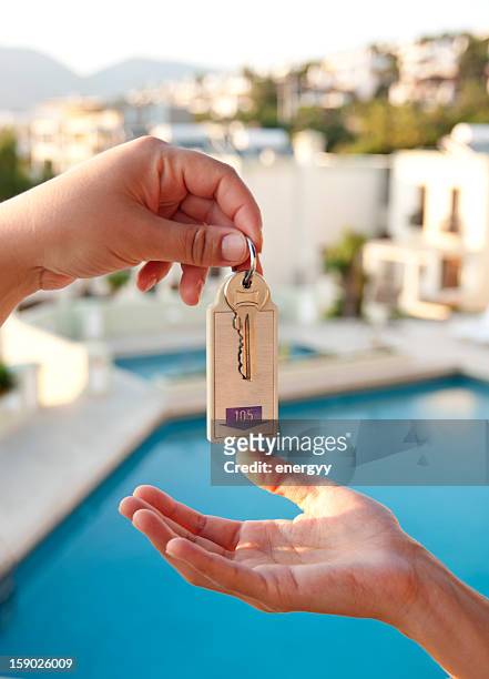 women gives hotel key - hotel key stock pictures, royalty-free photos & images