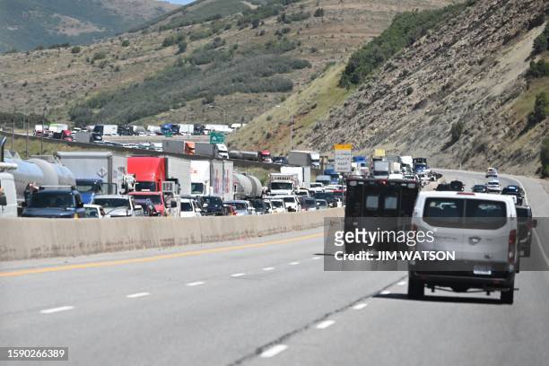 Vehicles sit in traffic as the Presidential motorcade, with US President Joe Biden on board, drives to a campaign reception in Park City, Utah, on...