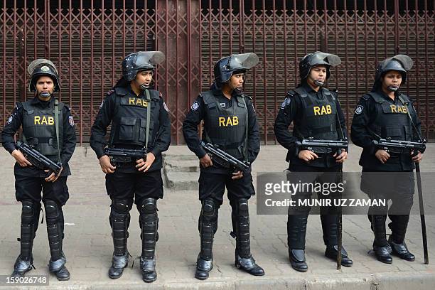 Bangladeshi elite force Rapid Action battalion members stand guard in front of the Bangladesh Nationalist Party office during a nationwide strike in...