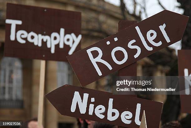 Protesters hold up sign posts prior to the annual Epiphany conference at the state opera house on January 6, 2013 in Stuttgart, Germany.