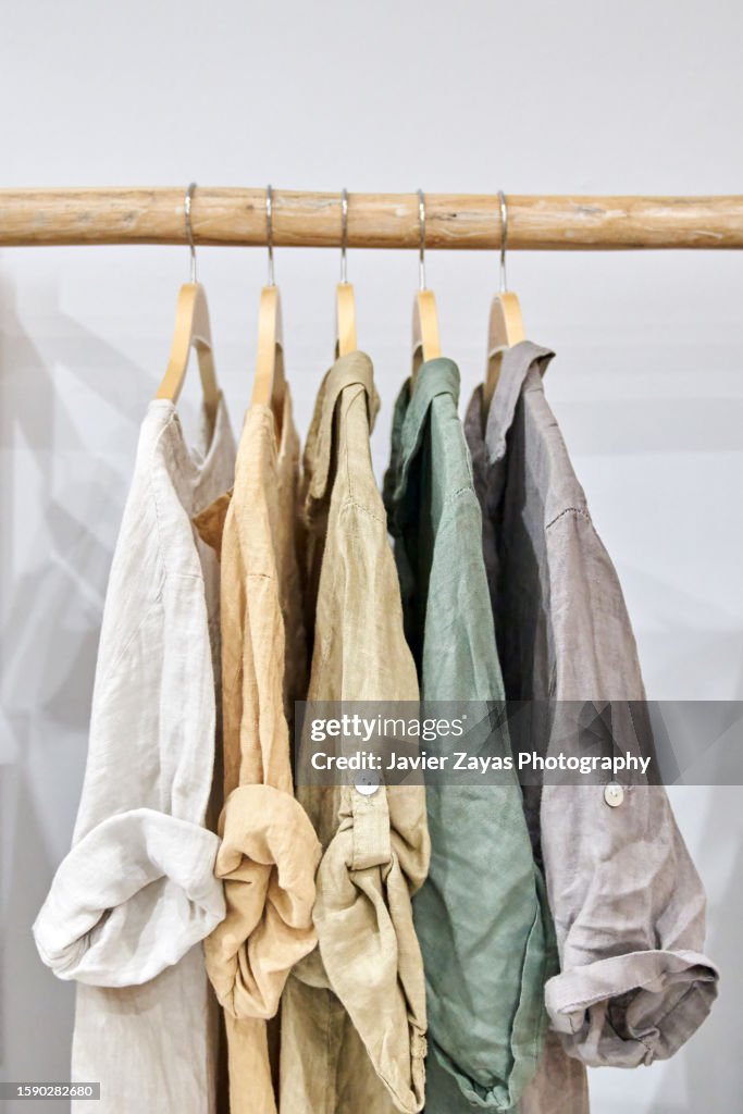 Fair trade linen organic clothes of neutral tones on hanger