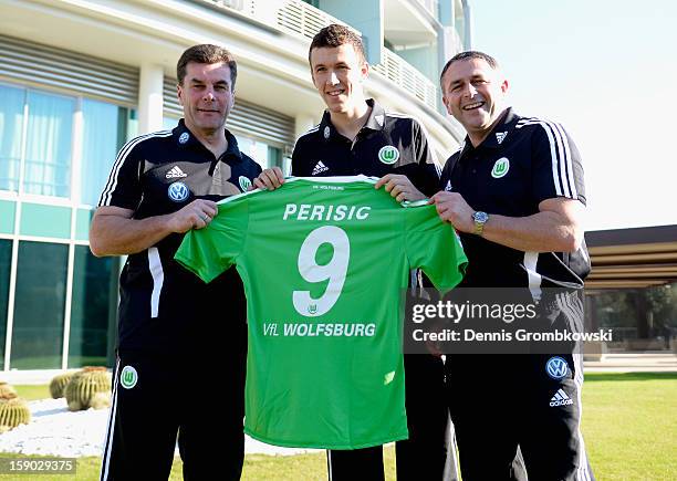 Head coach Dieter Hecking of Wolfsburg and manager Klaus Allofs present the croatian Forward Ivan Perisic who signed for VfL Wolfsburg during day...