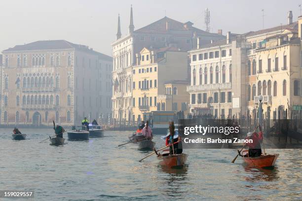 Participants dressed as 'Befana' row on Gran Canal during the traditional Epiphany Boat Race on January 6, 2013 in Venice, Italy. In Italy, Epiphany...