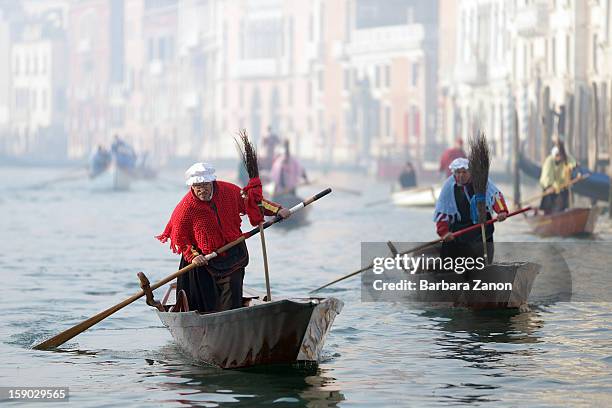 Partecipant dressed as 'Befana' rows on Gran Canal during the traditional Epiphany Boat Race on January 6, 2013 in Venice, Italy. In Italy, Epiphany...