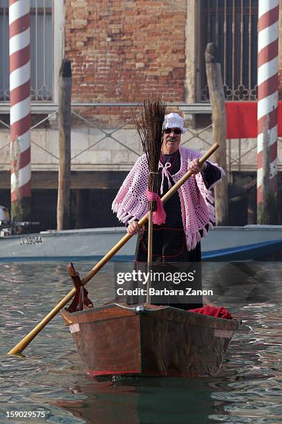 Participant dressed as 'Befana' rows on Gran Canal during the traditional Epiphany Boat Race on January 6, 2013 in Venice, Italy. In Italy, Epiphany...