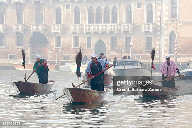Participants dressed as 'Befana' row on Gran Canal during the traditional Epiphany Boat Race on January 6, 2013 in Venice, Italy. In Italy, Epiphany...
