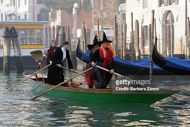 Participants dressed as 'Befana' row on Gran Canal during the traditional Epiphany Boat Race on January 6, 2013 in Venice, Italy. In Italy, Epiphany...