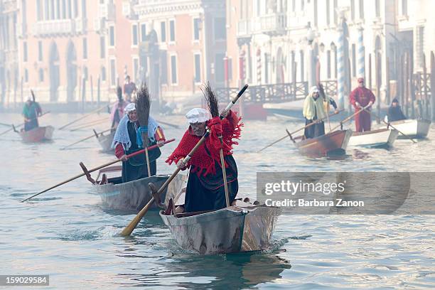 Participants dressed as 'Befana' row on Gran Canal during the traditional Epiphany Boat Race on January 6, 2013 in Venice, Italy. In Italy, Epiphany...