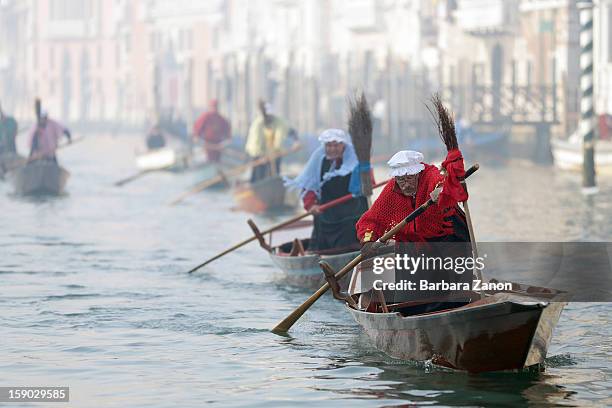 Participant dressed as 'Befana' rows on Gran Canal during the traditional Epiphany Boat Race on January 6, 2013 in Venice, Italy. In Italy, Epiphany...