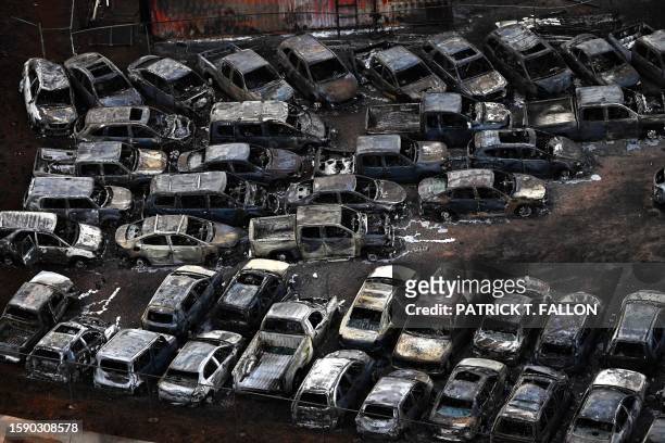 An aerial image taken on August 10, 2023 shows destroyed cars in Lahaina in the aftermath of wildfires in western Maui, Hawaii. At least 36 people...