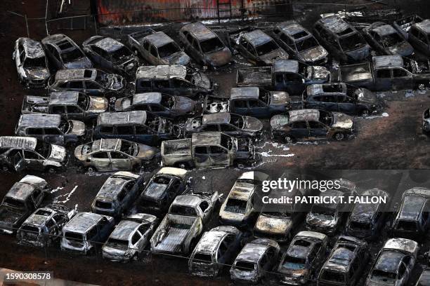 An aerial image taken on August 10, 2023 shows destroyed cars in Lahaina in the aftermath of wildfires in western Maui, Hawaii. At least 36 people...