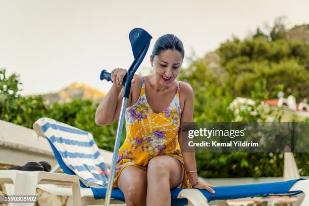 disabled woman having fun at pool - crutch stock pictures, royalty-free photos & images