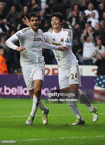 Danny Graham of Swansea City celebrates with Ki Sung-Yong as he scores their second goal during the FA Cup with Budweiser Third Round match between...