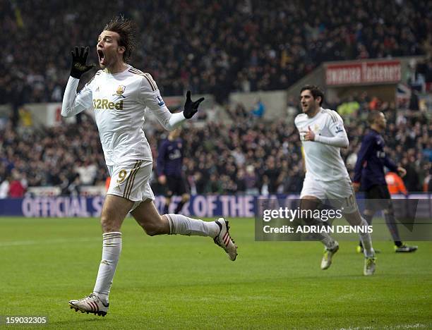 Swansea City's Spanish striker Miguel Michu runs to celebrate after scoring the opening goal against Arsenal during the FA Cup third round football...