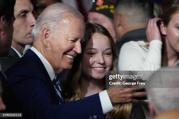 President Joe Biden takes a selfie with Emma Kate Cox, the daughter of Utah Governor Spencer Cox after he spoke at the George E. Wahlen Department of...