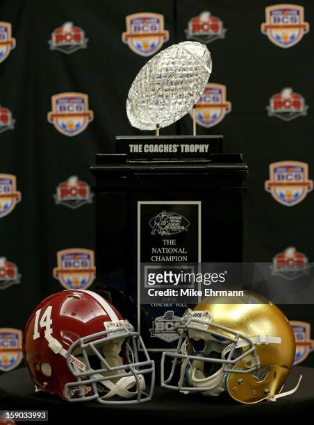 The Coaches Trophy sits with the helmets for the Notre Dame Fighting Irish and the Alabama Crimson Tide during the Discover BCS National Championship...
