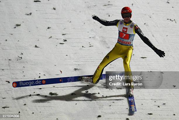 Andreas Wellinger of Germany celebrates and falls down during the first round for the FIS Ski Jumping World Cup event of the 61st Four Hills ski...